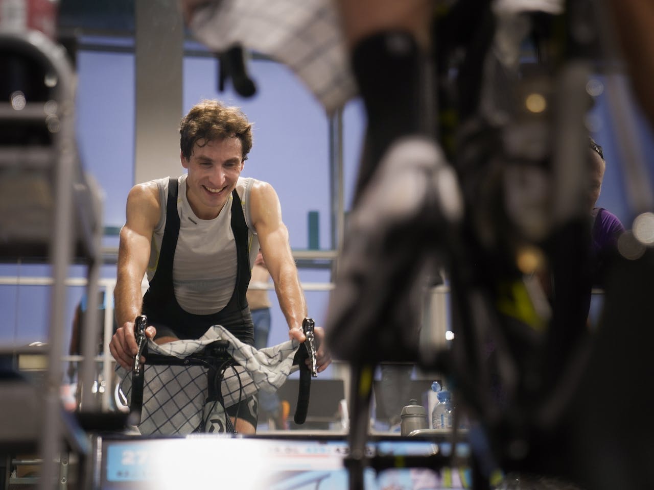 Man enjoying an intense indoor cycling workout, emphasizing fitness and healthy living.